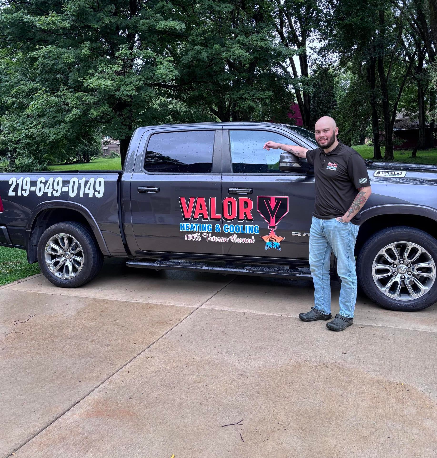 Matt Pomales, owner of Valor Heating and Cooling, beside the company truck